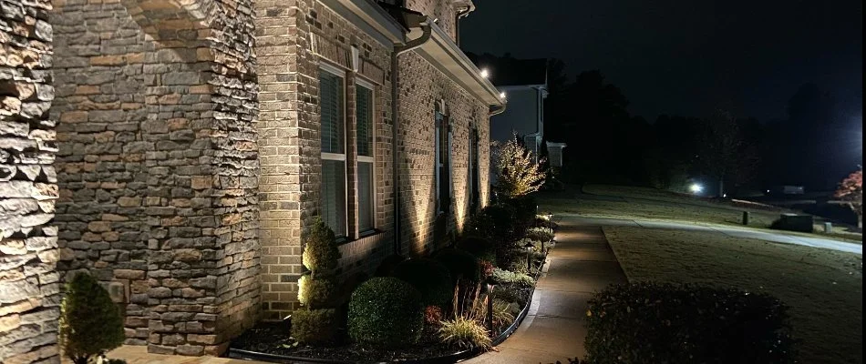 A house in Charlotte, NC, with landscape lighting.