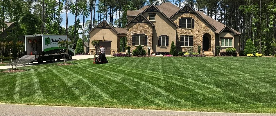 A front lawn in Charlotte, NC, being mowed with rotated patterns.