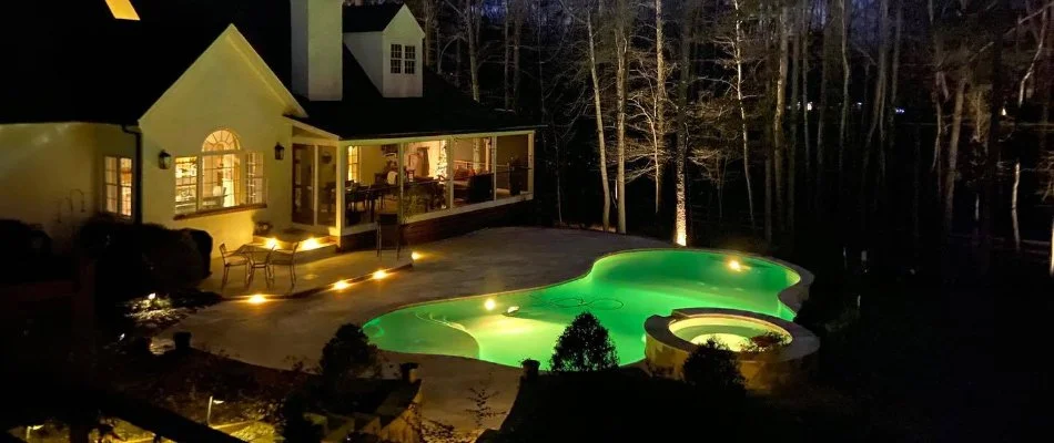 Outdoor space in Charlotte, NC, with pool and outdoor lights.