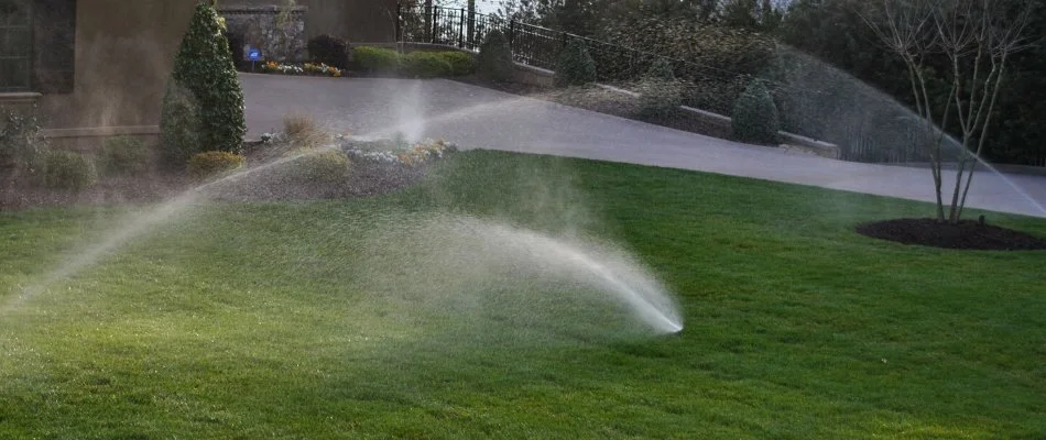 A residential lawn in Charlotte, NC, being watered by a sprinkler irrigation system.