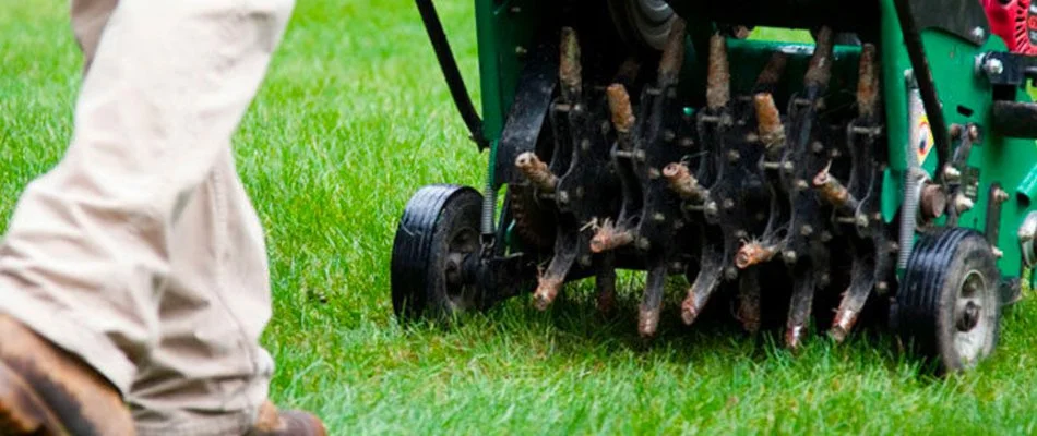 Aerator machine aerating a lawn in Pineville, NC.