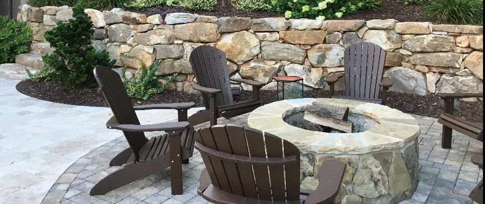 A stone fire pit with seating around it. 