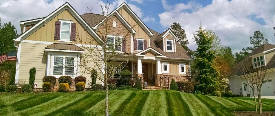 A home in Charlotte, NC, with vibrant, green grass.