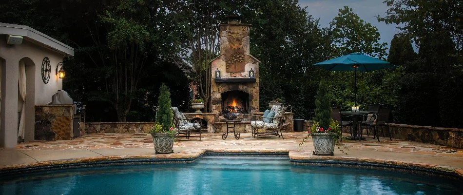 An outdoor living space in Charlotte, NC, with a fireplace and patio.