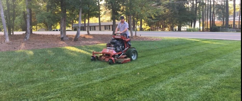 A professional mowing a lawn in Matthews, NC.