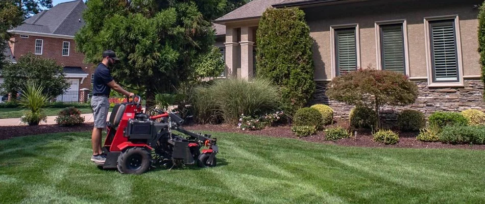 Professional aerating and overseeding a lawn in Huntersville, NC.