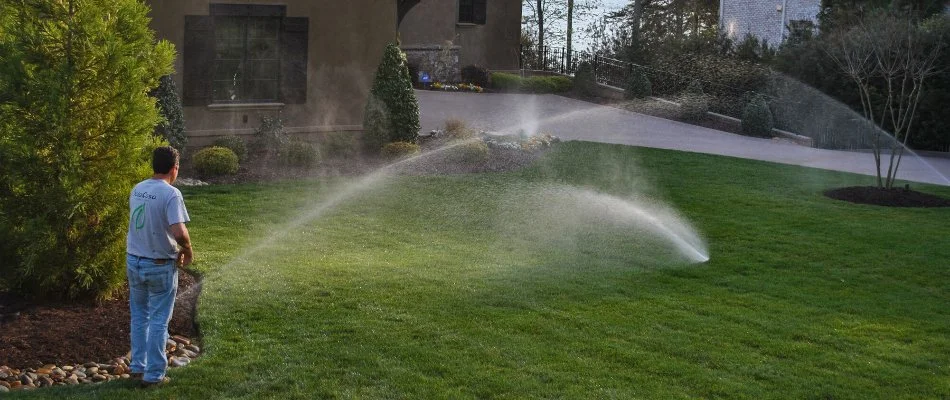 A professional monitoring an irrigation system in Matthews, NC.