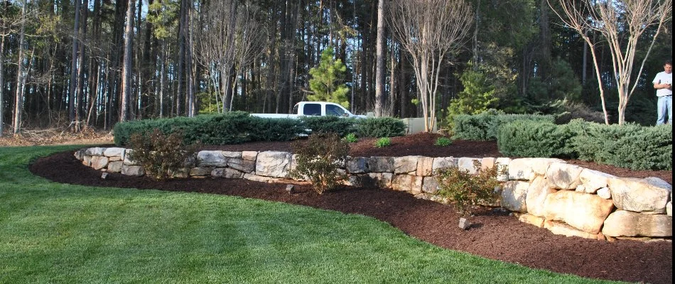 Retaining wall in Lake Norman, NC, surrounded by mulch and grass.