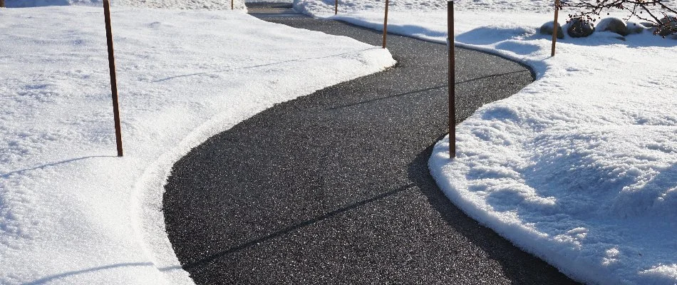 Snow along a cleared sidewalk in Charlotte, NC.